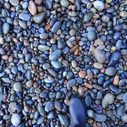 The stones on a shaded Slope Point beach.